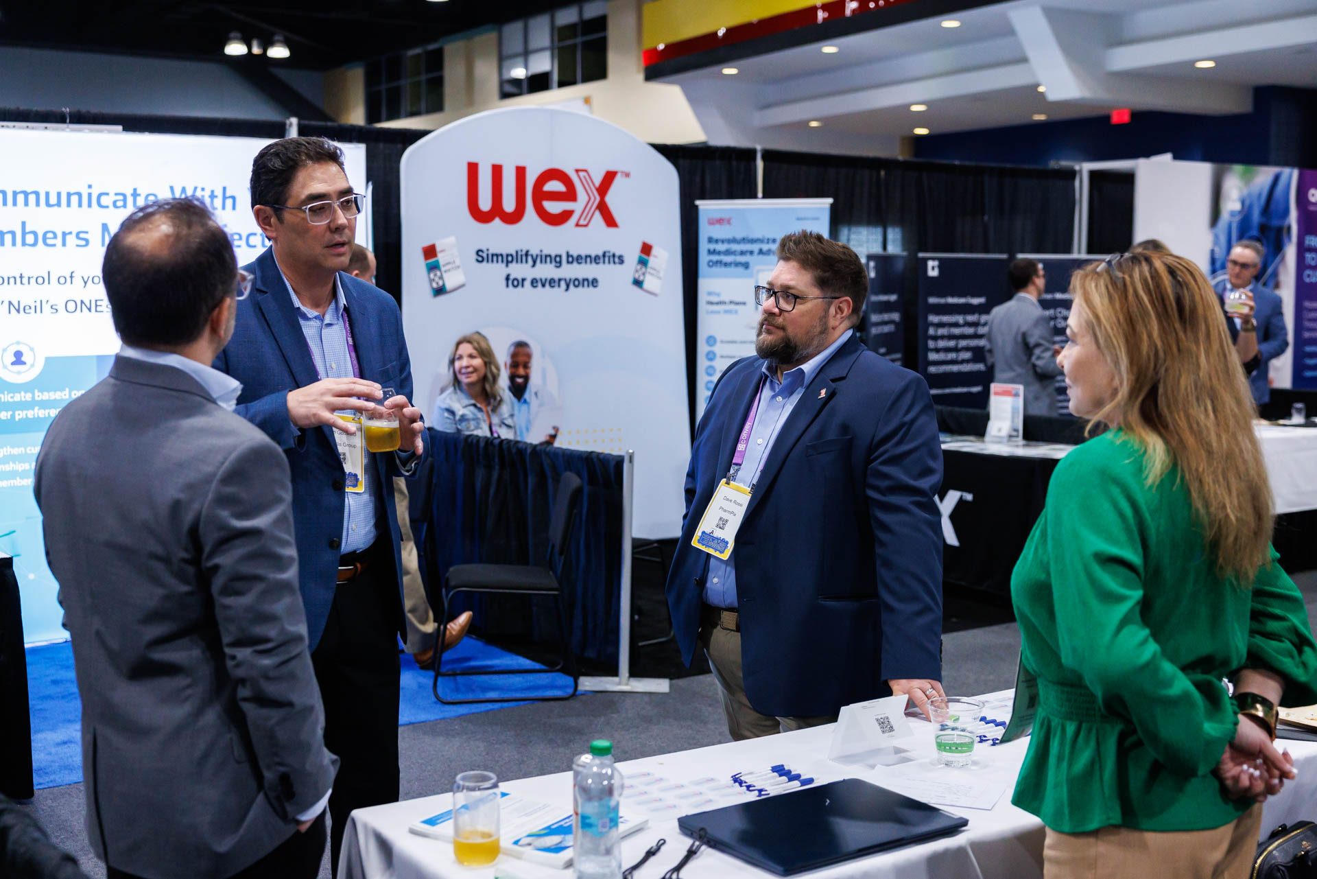 Sponsors and attendees speaking in the exhibit hall